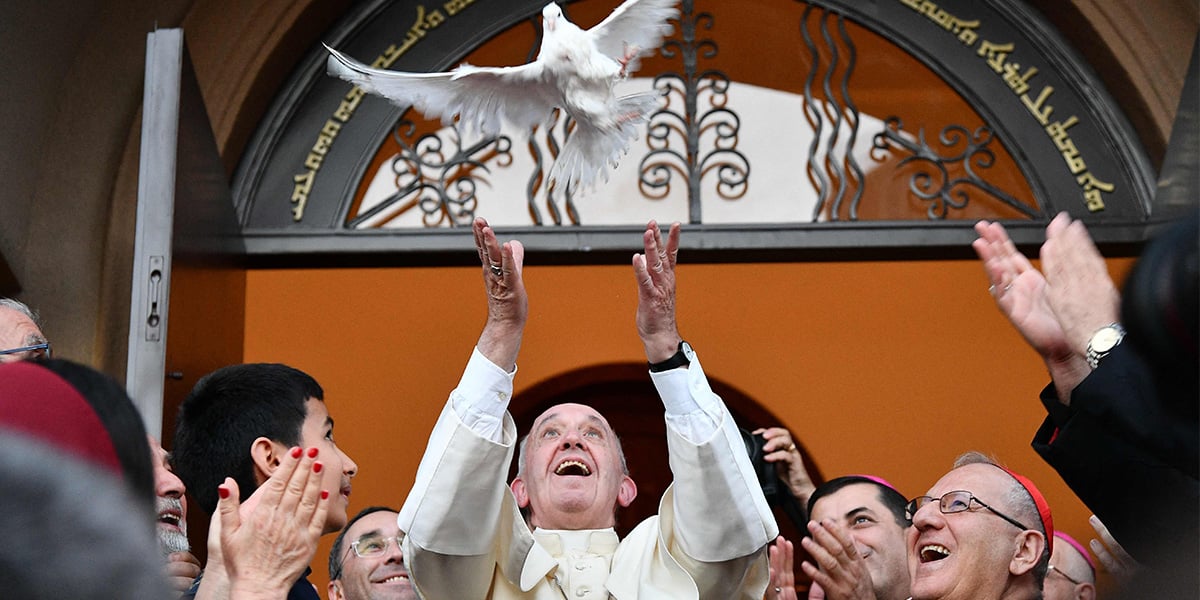 Pope Francis (C) releases a dove as a symbol of peace during a meeting with Chaldean community at the Catholic Church of St Simon Bar Sabbae in Tbilisi, on September 30, 2016. — AFP