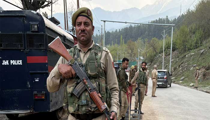 Indian police officers stand guard at a check point following a attack, near Pahalgam in IIOJKs Anantnag district, April 22, 2025. — Reuters