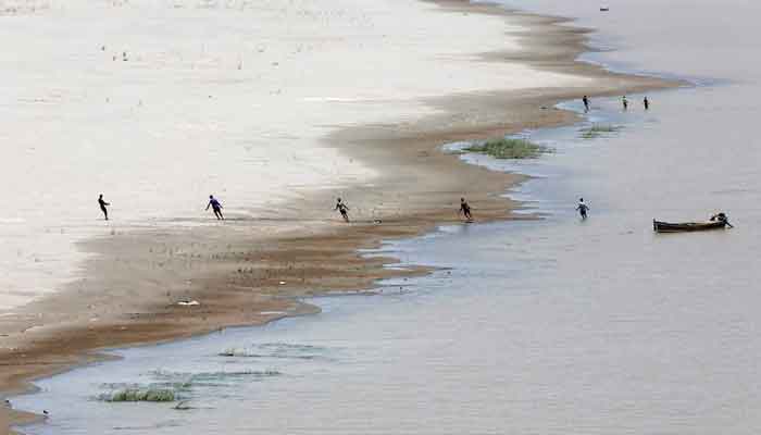 Fishermen pull a fishing net as they catch fish along the Indus River, Hyderabad, Pakistan June 11, 2017. — Reuters