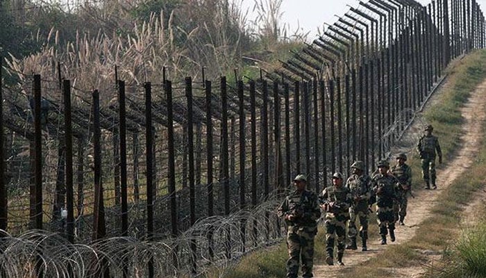In this file photo, Indian Border Security Force personnel patrol along the Line of Control. — AFP/File