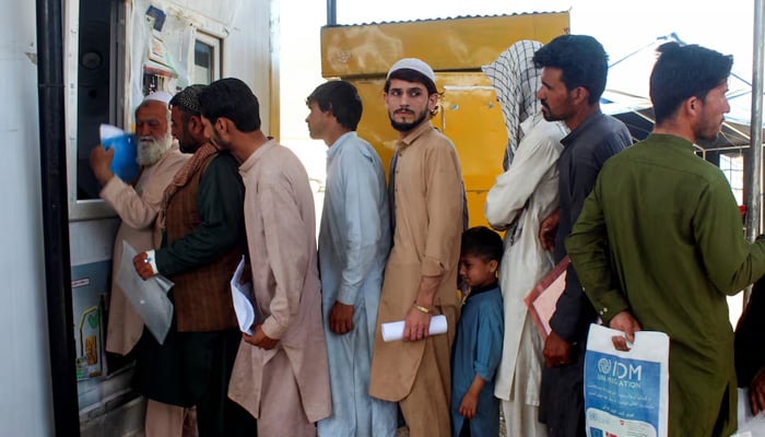 Afghan nationals, who were expelled from Pakistan, stand in queue for registration upon their arrival at the Omari refugee camp in Mohmand Dara, Torkham border, Nangarhar province, Afghanistan, April 15, 2025. — Reuters