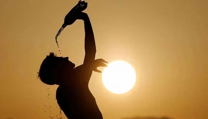 A man cools down with water in this undated image. — Reuters/File