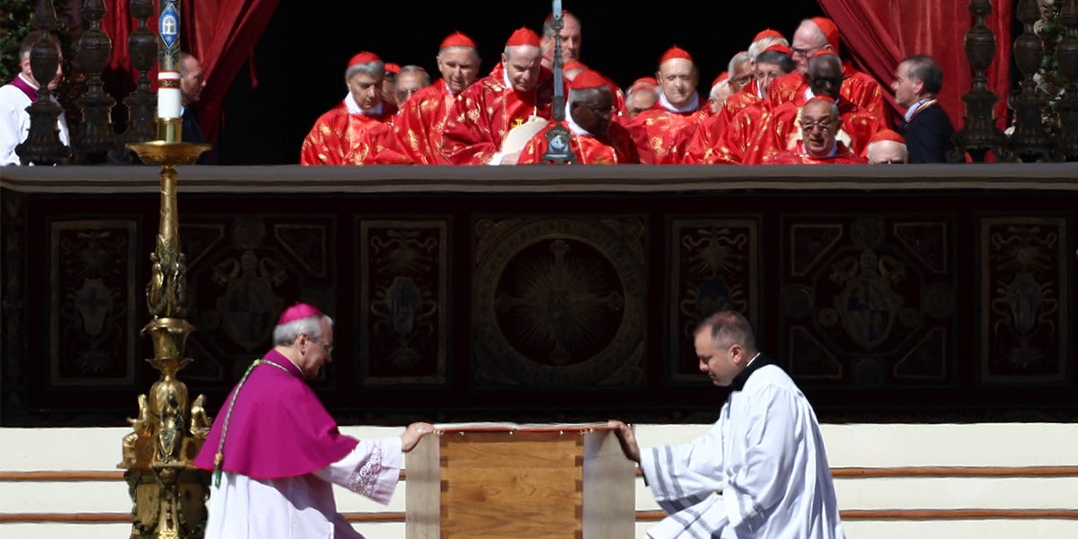 Clergy members kneel by the coffin of Pope Francis during his funeral Mass in St Peters Square at the Vatican, April 26, 2025. — Reuters