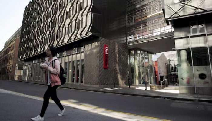 A student walks from high density housing near the campus of the University of Technology in Sydney, on April 1, 2016. —Reuters