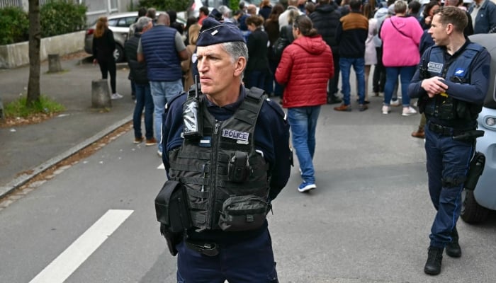 This representational image shows a French Police officer and a Police Municipal officer securing a school after a knife attack in Nantes, western France, on April 24, 2025. — AFP
