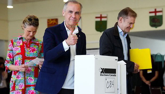 Liberal Leader Mark Carney votes with his wife Diana Fox Carney in Ottawa, Ontario, Canada, April 28, 2025. — Reuters