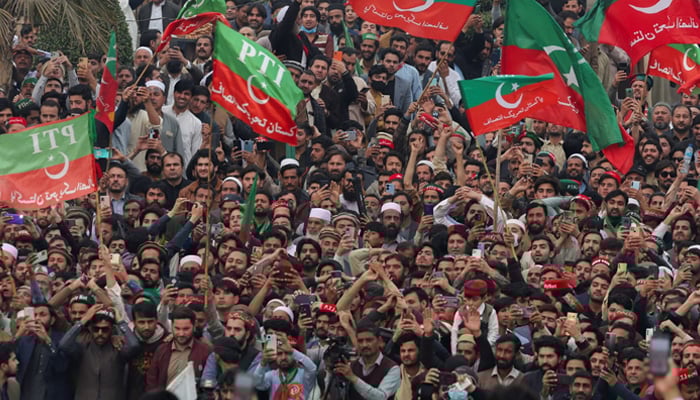 Supporters of Pakistan Tehreek-e-Insaf (PTI) wave flags as they protest demanding free and fair results of the elections, in Peshawar on February 17, 2024. — Reuters