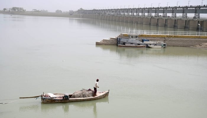 A fisherman fishing on his boat in Indus River near Hyderabad on April 26, 2025. — APP