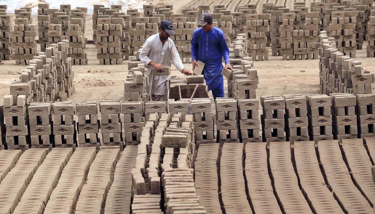 Labourers are busy working at brick kiln in Peshawar. — APP