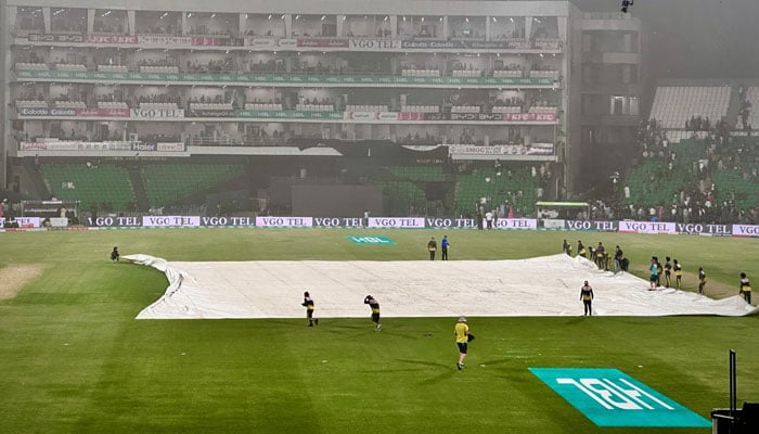 Ground staff cover the pitch as rain disrupts the Pakistan Super League (PSL) Season 10 clash between Quetta Gladiators and Lahore Qalandars at Gaddafi Stadium, Lahore, on May 1, 2025. — Facebook/Pakistan Super League