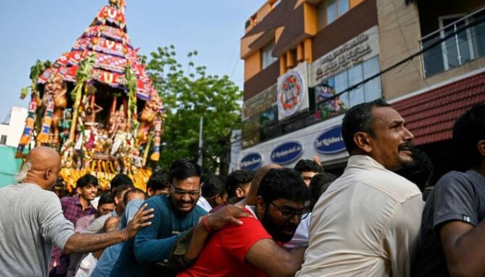 Hindu devotees pull a chariot as they take part in a religious procession during the chariot festival. —AFP/ File