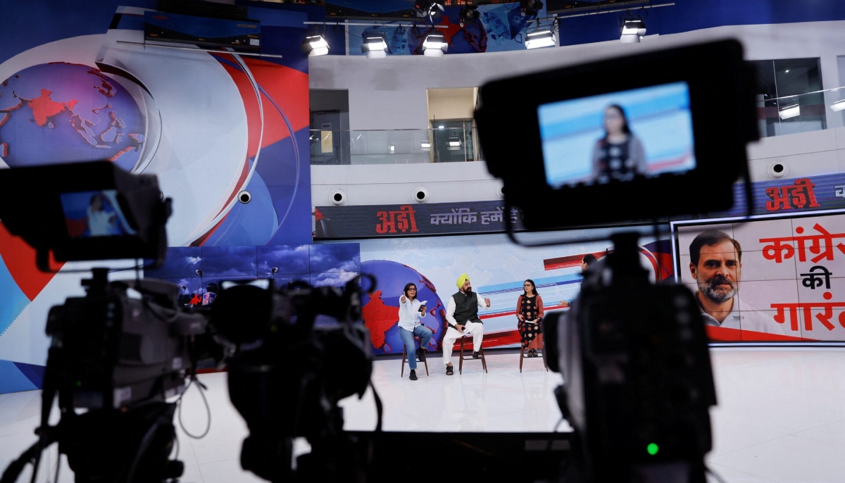 Neha Singh Rathore, 27, a folk singer and social media content creator, reacts during a debate where she was asked to be a panelist, inside the studio of a national television news network in Noida, India, April 5, 2024. — Reuters