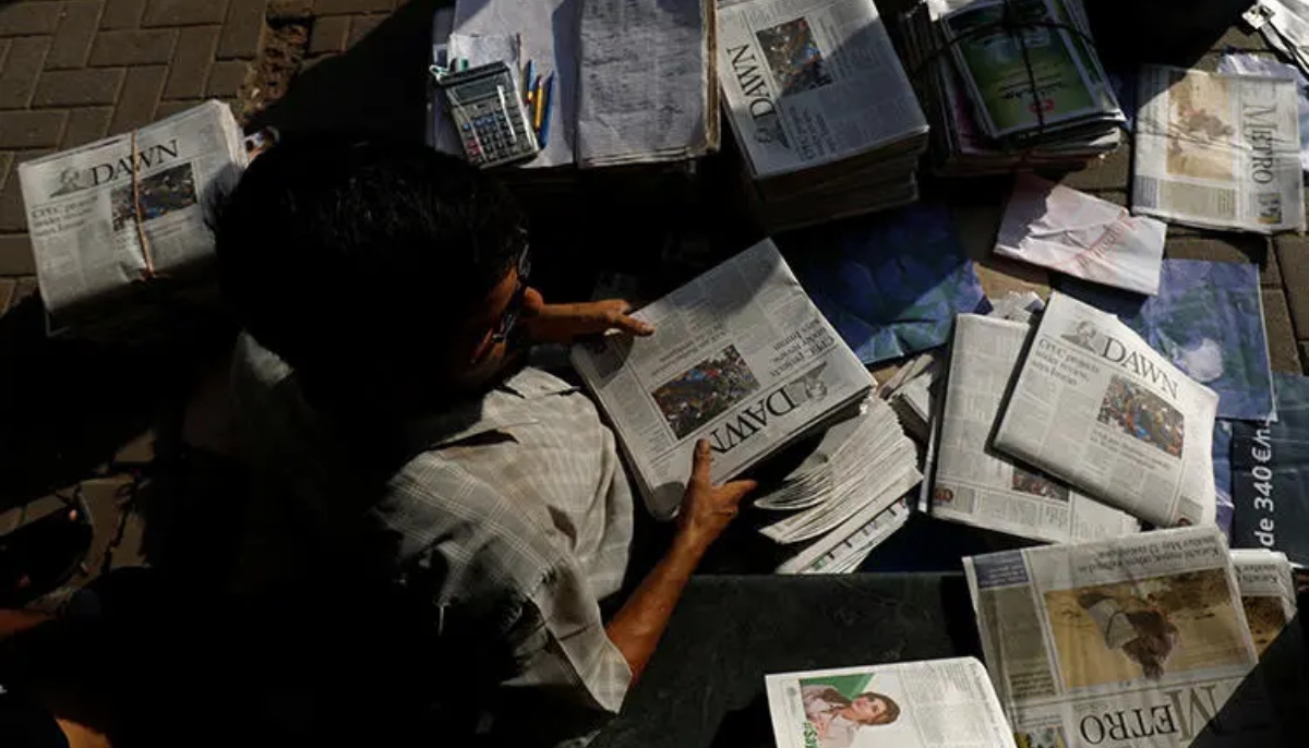 A newspaper vendor is seen in Karachi on October 7, 2018. — Reuters