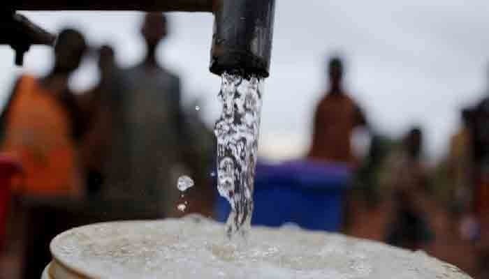 The image shows people waiting for their turn to fill their vessels with water. — APP/File