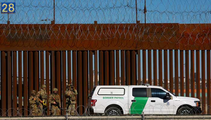 US offers $1,000 stipend to encourage migrants to self-deport 1 Members of the Texas National Guard stand guard near the border wall between Mexico and the United States, as seen from Ciudad Juarez, Mexico, January 14, 2025. — Reuters