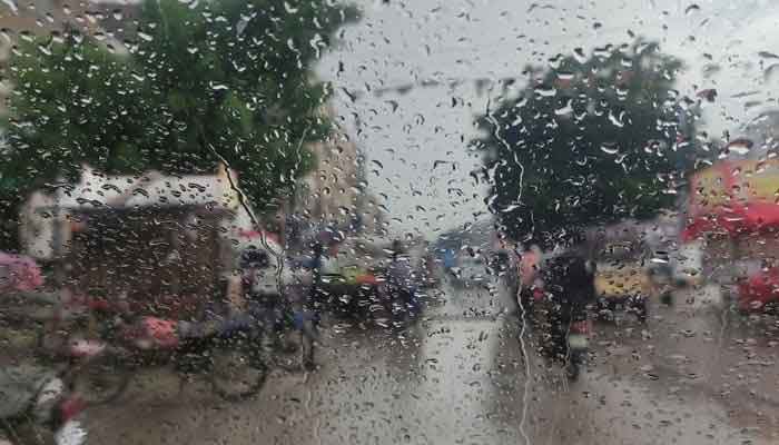 The image shows raindrops on a car window in Karachi. — Reuters/File