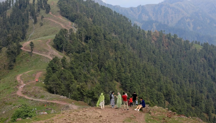 Tourists stand at a view point at Pir Chinasi, a tourist attraction in AJK, May 4, 2025. — Reuters