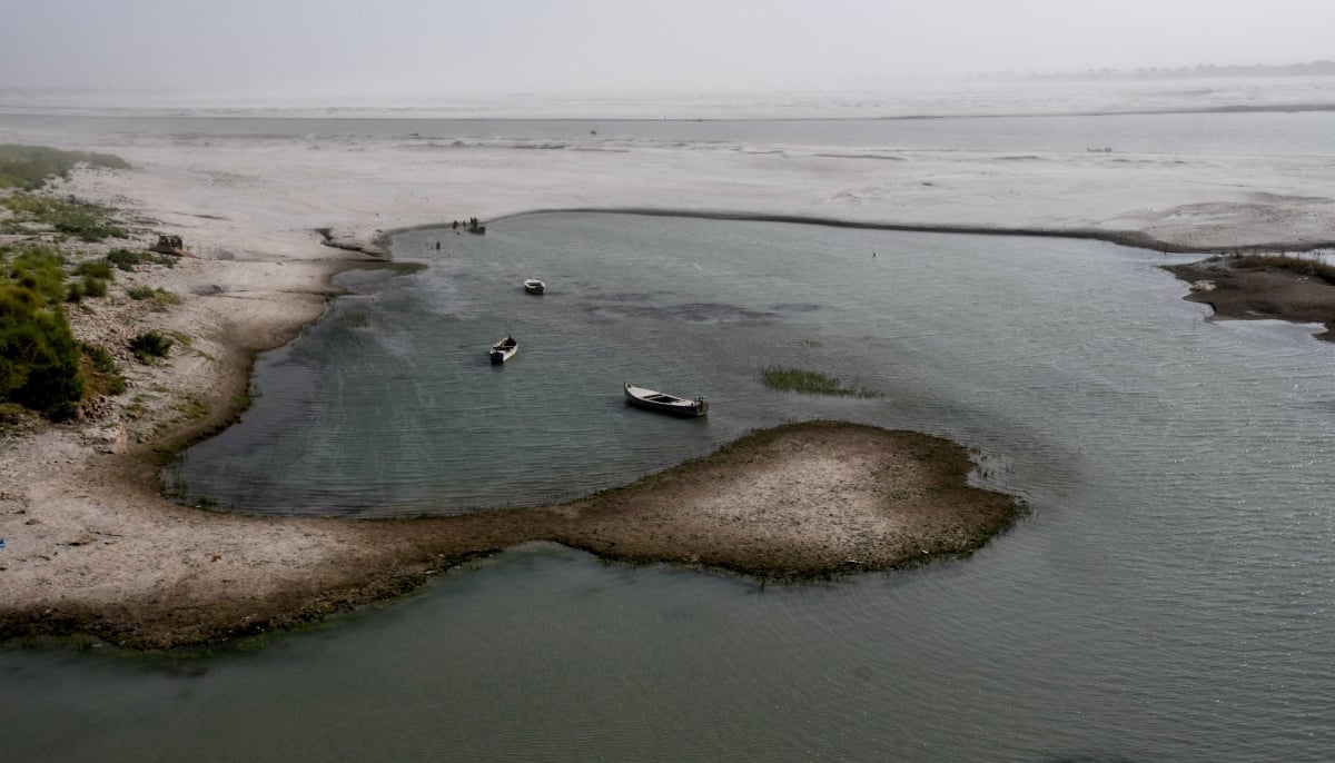 View of boats in the water on the dry riverbed of the Indus River in Hyderabad on April 24, 2025. — Reuters