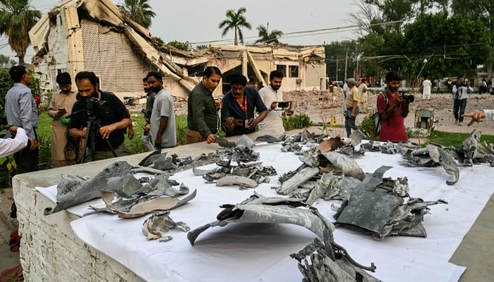 Journalists look at wreckage of Indian missiles at the Government Health and Educational complex in Muridke about 30 kilometres away from Lahore, on May 7, 2025. —AFP