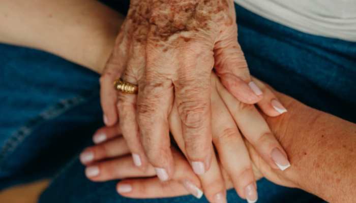 A representational image of hands showing the bond between mother and her daughters. — Canva