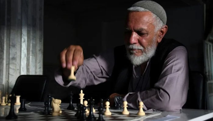 A chess player attends a tournament in Kandahar on July 30, 2022 — AFP