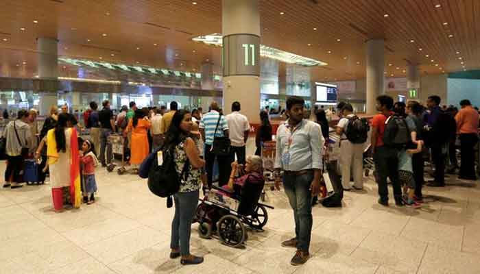 Passengers wait for their luggage at a conveyor be at the Chhatrapati Shivaji International airport in Mumbai, India, February 7, 2017. — Reuters