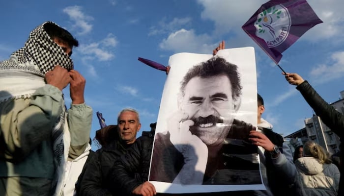 A demonstrator holds a picture of jailed Kurdish militant leader Abdullah Ocalan during a rally in Diyarbakir, Turkey, on February 27, 2025. —Reuters