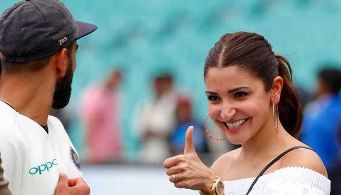 India captain Virat Kohli looks at his wife Anushka Sharma as he celebrates with teammates after winning the Test series at the Sydney Cricket Ground — AFP