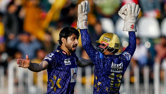Quetta Gladiators Abrar Ahmed (L) celebrates with a teammate after taking the wicket of Peshawar Zalmis Mohammad Haris during the Pakistan Super League (PSL) match between Peshawar Zalmi and Quetta Gladiators at the Rawalpindi Cricket Stadium, April 12, 2025 — AFP