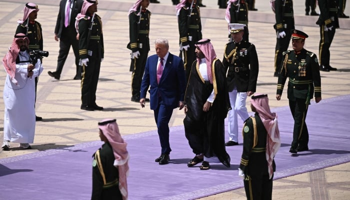 (From left) US President Donald Trump walks with Saudi Crown Prince Mohammed bin Salman after reaching Riyadh on May 13, 2025. — AFP