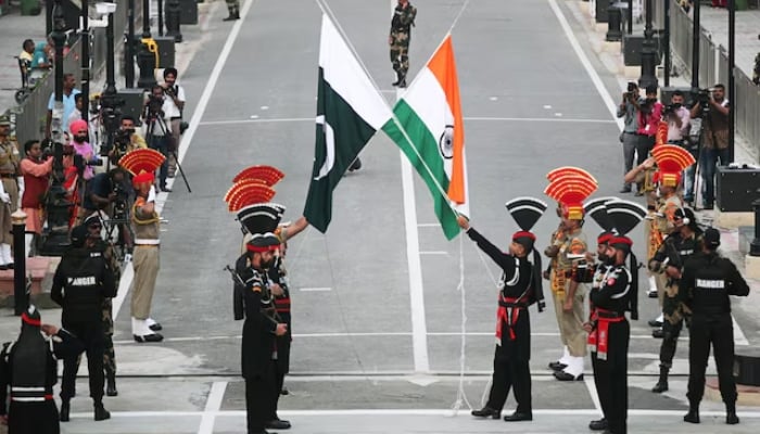 Pakistani Rangers (wearing black uniforms) and Indian Border Security Force (BSF) officers lower their national flags during a parade on Pakistans 72nd Independence Day, at the Wagah border, Lahore, August 14, 2019. — Reuters