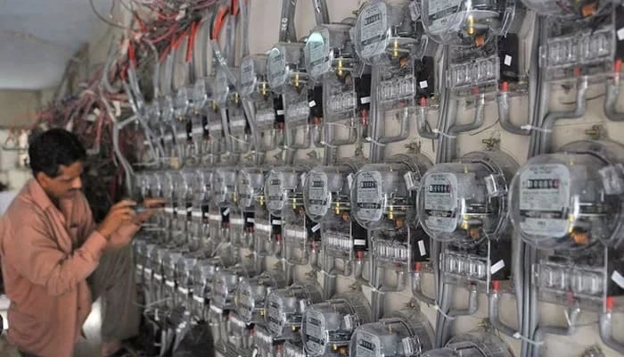 In this undated photo, a technician fixes new electricity meters at a residential building in Pakistan. — AFP/File