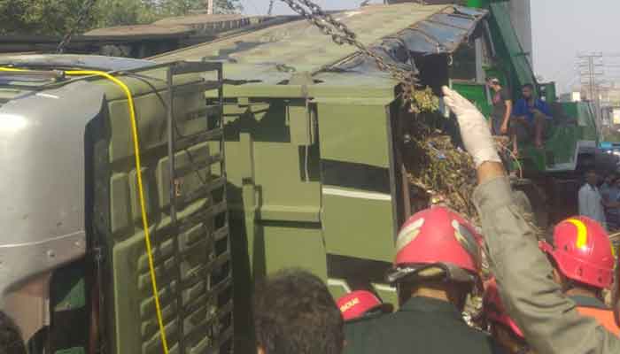Rescue officials can be seen at the site of dumper truck accident in  Lahore.