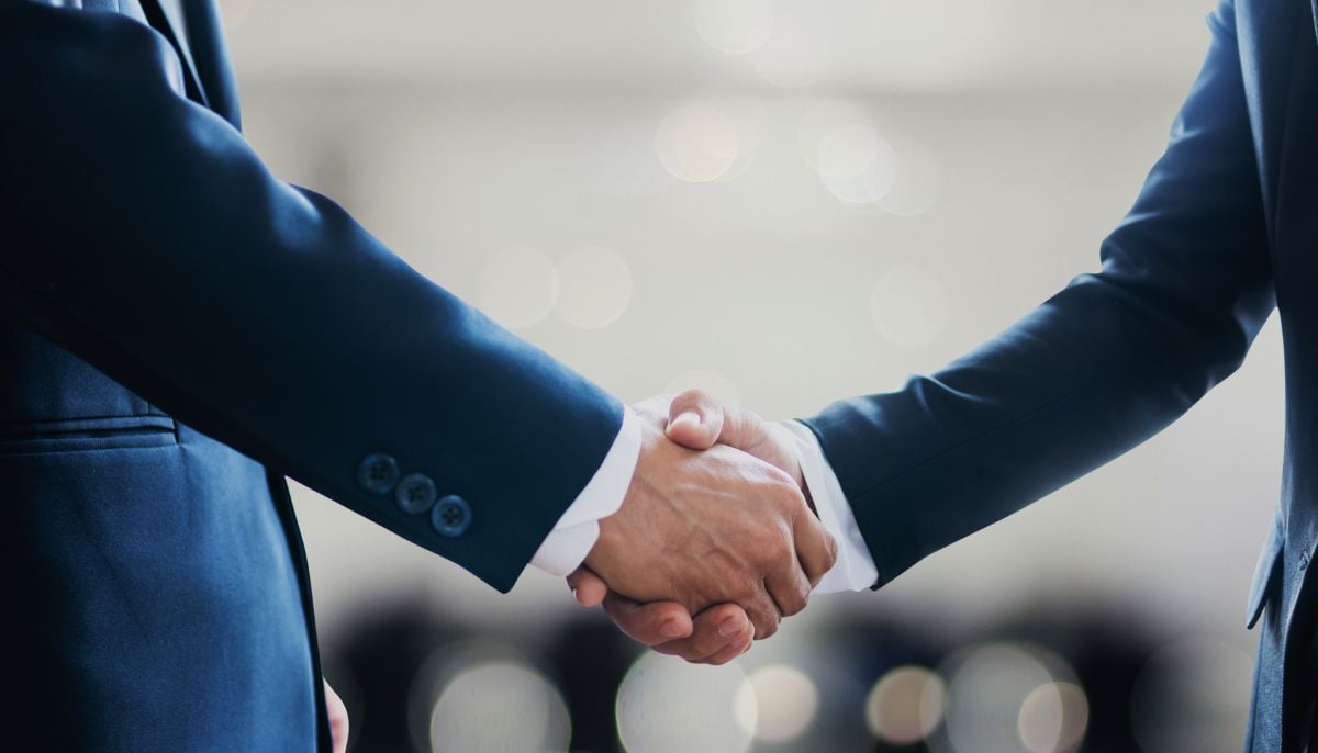 A representational image of two men shaking hands. — Canva