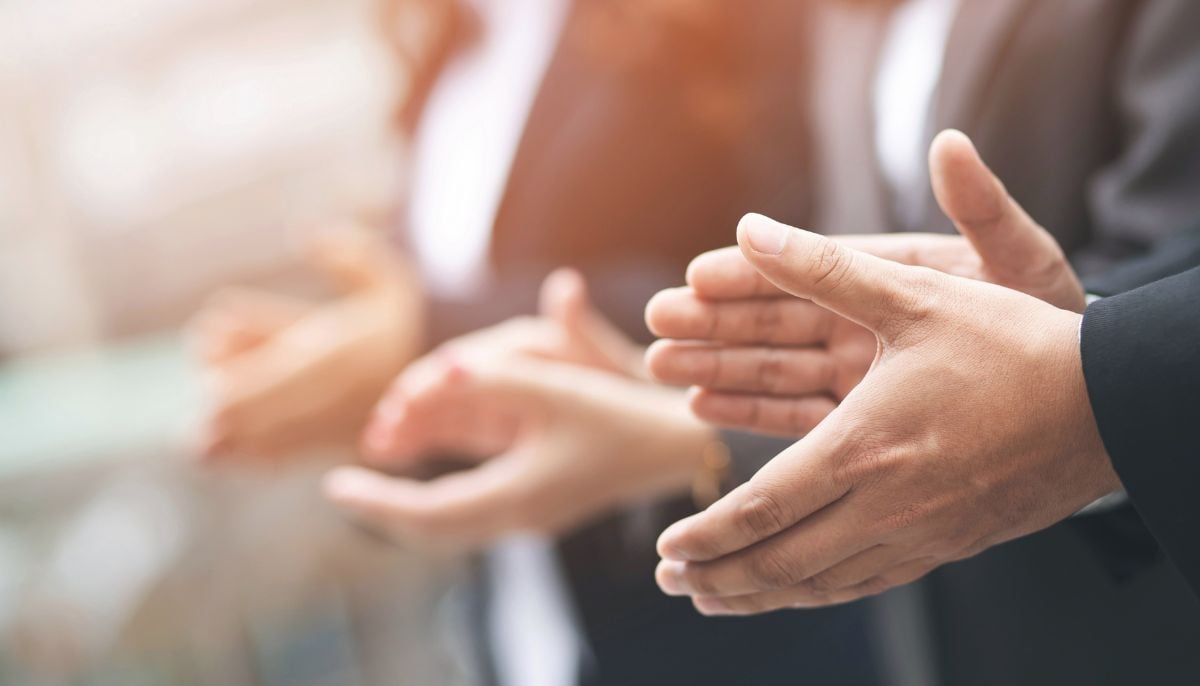 A representational image of people clapping. — Canva