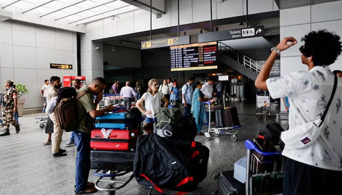 Passengers wait at Terminal 2 of Indira Gandhi International Airport in New Delhi, India, July 1, 2024 — Reuters