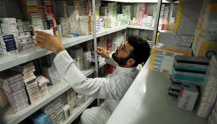 A man sorts and arranges medicine packs at a pharmacy store in Peshawar on March 28, 2019. — Reuters