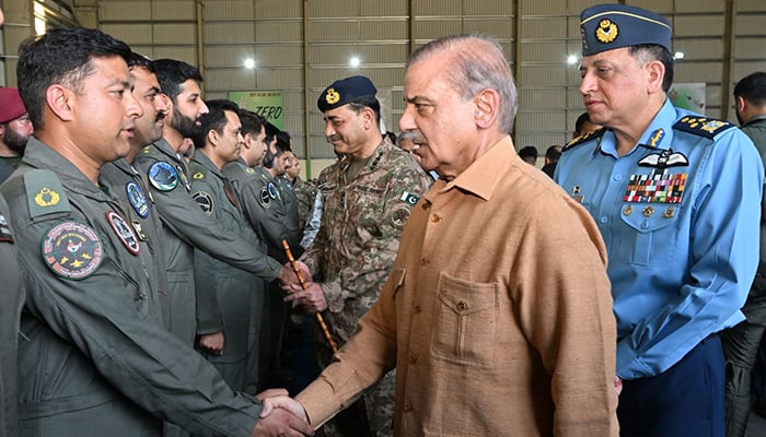 PM Shehbaz Sharif shakes hands with PAF pilots at PAFs operational base at Kamra on May 15, 2025. COAS General Syed Asim Munir and Chief of the Air Staff Air Chief Marshal Zaheer Ahmed Baber Sidhu are also present.— ISPR