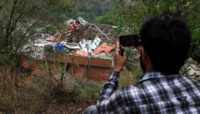 A media person films Bilal Mosque after it was hit by an Indian strike in Muzaffarabad, the capital of Azad Kashmir on May 7, 2025. — Reuters