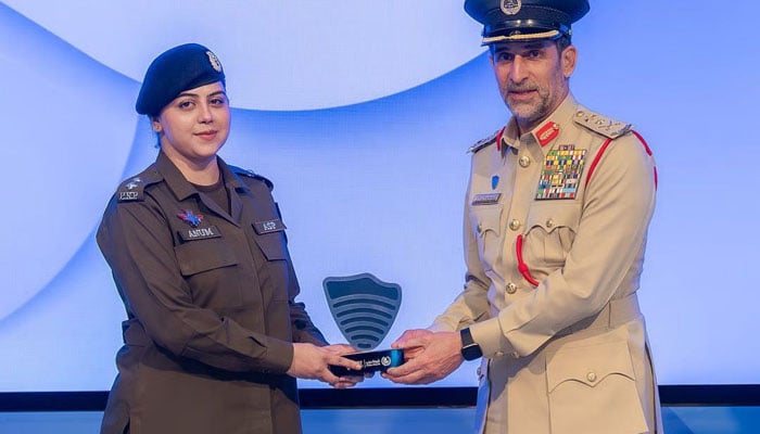 Anum Khan Muhammad Sher receives the Excellence in Criminal Investigation Award from Lieutenant General Abdullah Khalifa Al Marri, Commander-in-Chief of Dubai Police during the 2025 World Police Summit Awards in Dubai. — Dubai police.