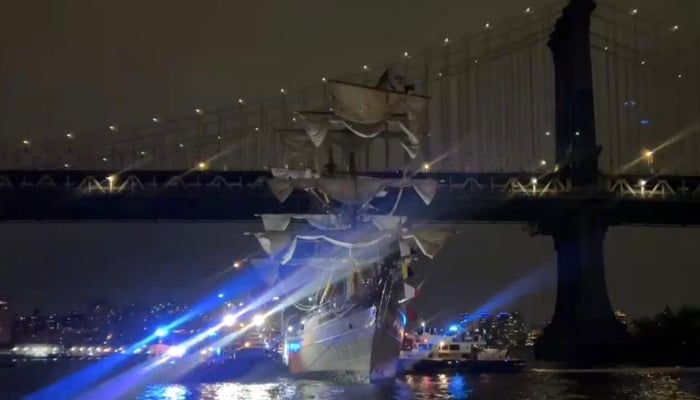 The ship sailing near the Brooklyn Bridge in New York on May 17, 2025. — AFP