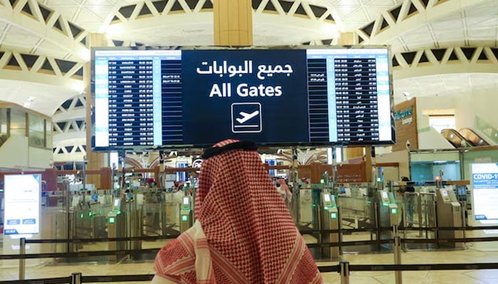 A Saudi man checks the flight timings at the King Khalid International Airport in Riyadh, Saudi Arabia, May 16, 2021 — Reuters