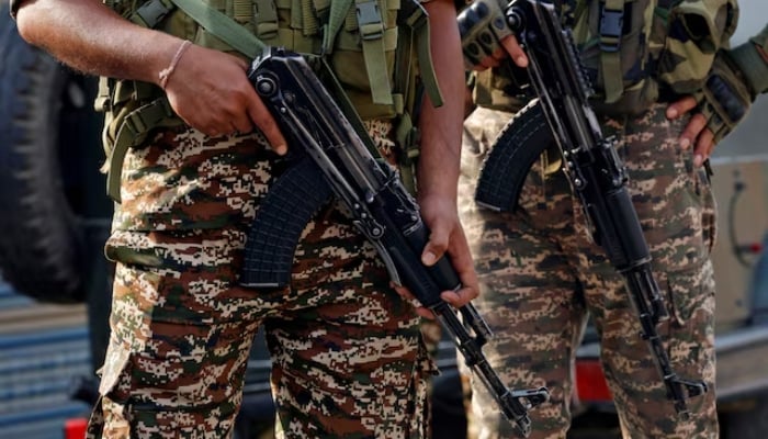 Indian security force personnel stand guard near the site of a fighter jet crash in Wuyan in IIOJKs Pulwama district May 7, 2025. — Reuters