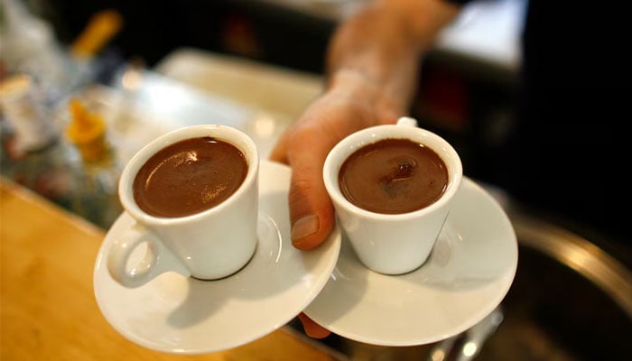 A waiter carries two cups of Turkish coffee at a coffee shop in Istanbul October 19, 2007 — Reuters