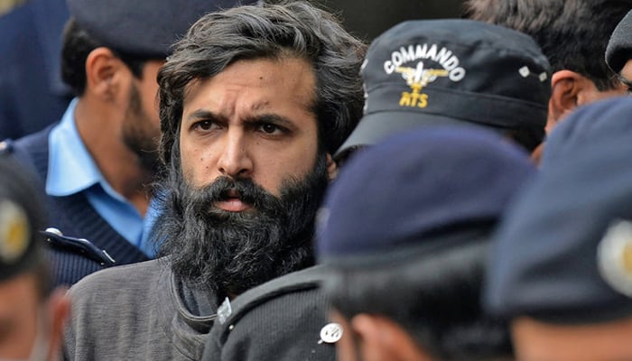 Zahir Jaffer (centre), convicted to murder Noor Mukadam, arrives in a court in Islamabad, on February 24, 2022. — AFP