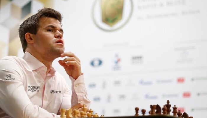 Magnus Carlsen of Norway sits in front of a chess board before a game.— Reuters/File