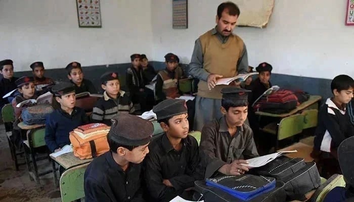 A teacher takes a class in a school in Peshawar. — AFP/File