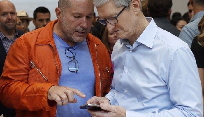 Apple CEO Tim Cook (right) plays with an iPhone as Jonathan Ive, Apples Chief Design Officer, looks on during a launch event in Cupertino, California, US September 12, 2017. — Reuters