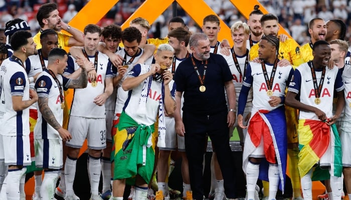 Tottenham players and Tottenham Hotspur´s Greek-Australian Head Coach Ange Postecoglou celebrate their victory after winning the UEFA Europa League final football match between Tottenham Hotspur and Manchester United at San Mames stadium in Bilbao on May 21, 2025. — AFP