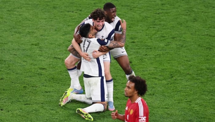 Tottenham Hotspurs Kevin Danso, Cristian Romero and Archie Gray celebrate winning the Europa League as Manchester Uniteds Joshua Zirkzee looks dejected, San Mames, Bilbao, Spain, May 21, 2025. — Reuters